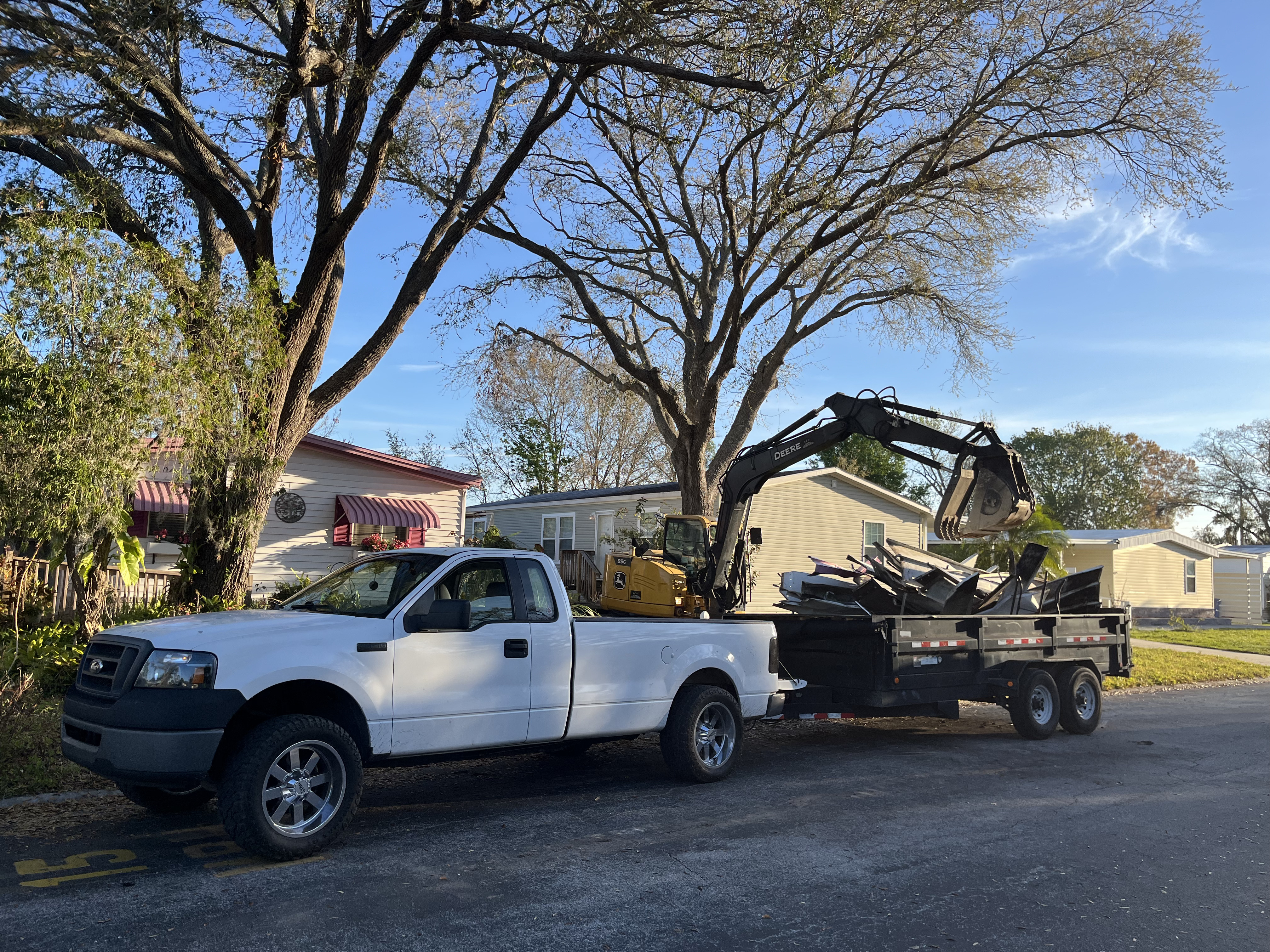Dump trailer loaded with structural debris after a demolition job in Lakeland, FL